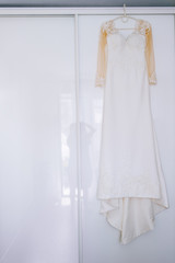 wedding dress on the white background of the window