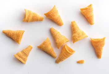 Crunchy corn snacks on a white background,top view