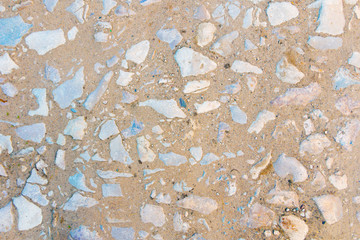 Medium sized stones in the sand top view