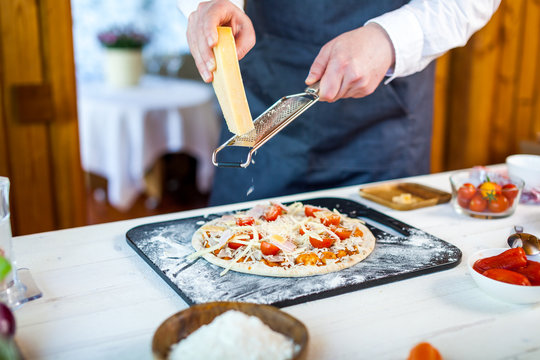 closeup hands of chef making fresh homemade traditional italian pizza. wallpaper for pizzeria and cooking food concept