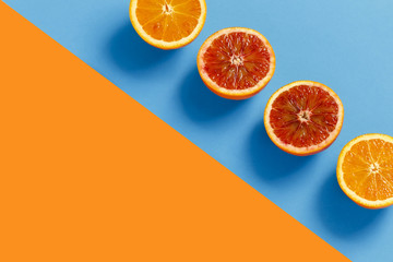 Oranges cut in half on a orange and blue background
