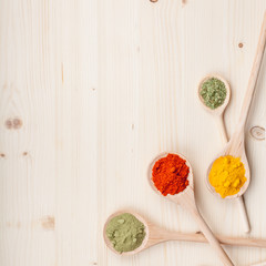 spices and herbs on kitchen wooden table background with copy space for text. food, cooking and restaurant concept. flat lay colorful composition, top view