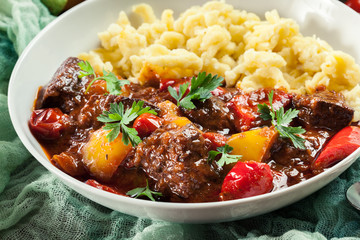 Hungarian beef goulash serwed with galuska noodles