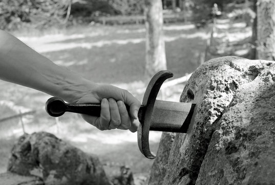 Magic Sword Excalibur and the arm of Knight in the forest