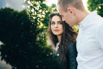 Fototapeta premium A young, sympathetic couple walks through the streets of the city