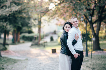 Fototapeta premium A young, sympathetic couple walks through the streets of the city