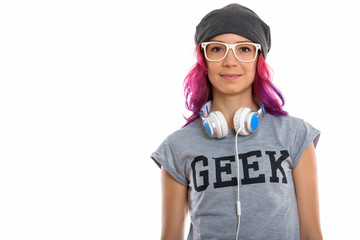 Studio shot of geek girl wearing eyeglasses with headphones arou