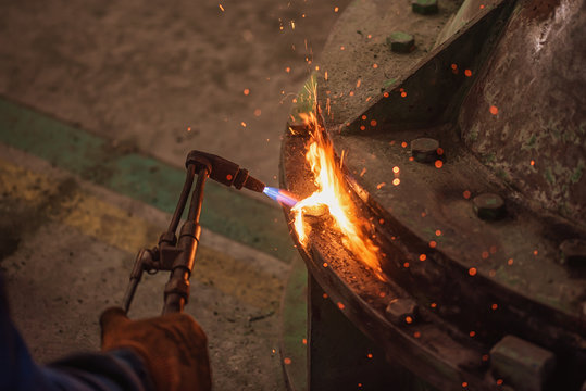Metal cutting with acetylene and oxygen gas torch. Soft focus due to high ISO and shallow Depth Of Field.