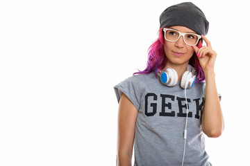 Studio shot of geek girl holding eyeglasses and thinking with he