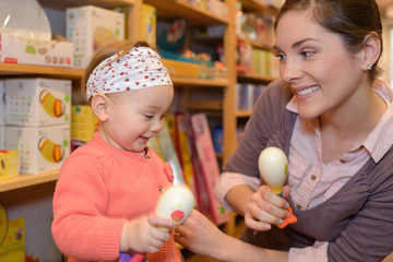 young mother her daughter shopping at the toy store