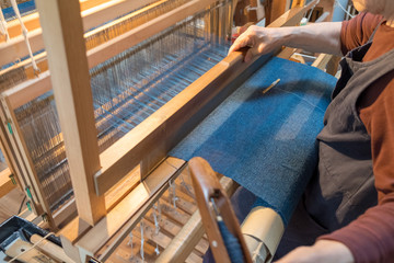 A landscape weaving a hand-woven cloth.
