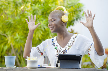 young beautiful and happy black African American woman enjoying outdoors at cafe working with...