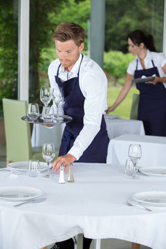 waiter setting a table at the restaurant