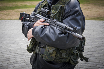 man aiming with an AK-47 with reflex sight, separatist. Male mags in the Kalashnikov. reloading the...