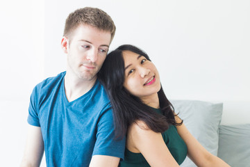 Couple with good communication skills.  White background laying on bed and happy.