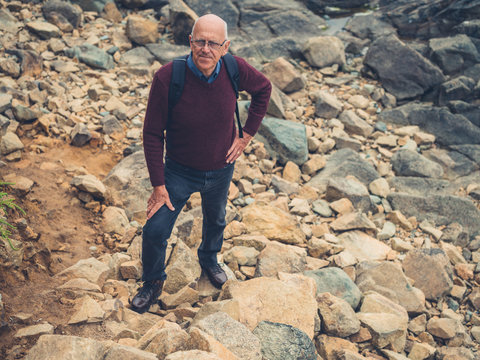 Senior man standing on rocks