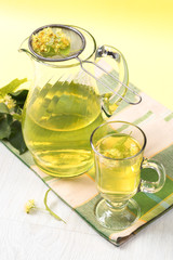 Tea served from the carafe with linden flowers on a napkin