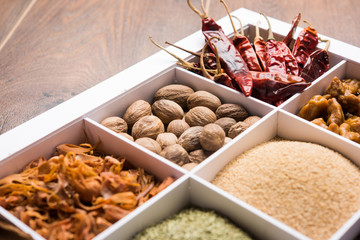 Indian Spices in white wooden box with cells, selective focus.