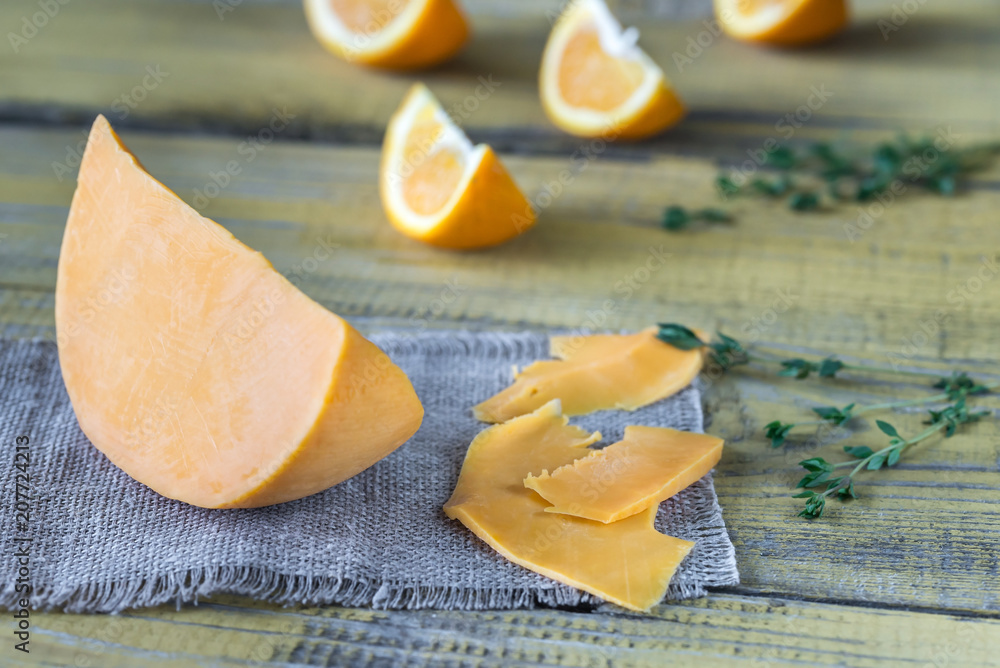 Poster Mimolette cheese on the wooden board