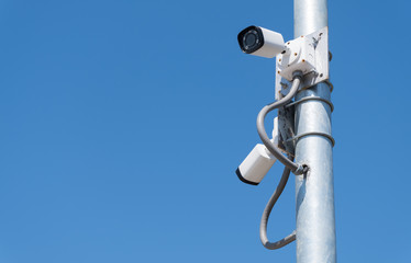 Security camera with blue sky.