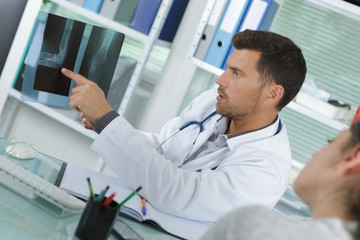 doctor showing to the patient the xray result
