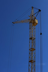 Construction crane against the blue sky.
