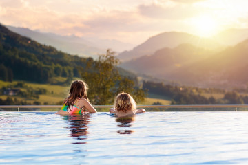 Family in swimming pool with mountain view