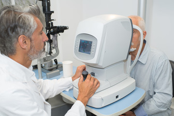 Senior man having eye test