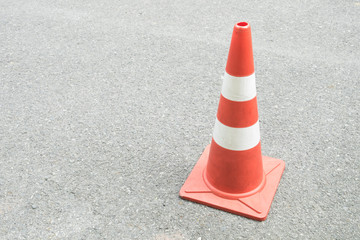 The traffic cone on the road in sunshine day. copy space background.