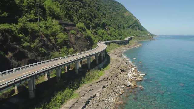 Aerial view of Patapat viaduct in the coast of Pagudpud, Ilocos Norte. Highway with bridge by coast sea near the mountains. Philippines, Luzon.