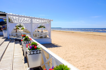 Terrace cafe with canopy. Decorative element. Interior decoration. Restaurant by the sea. Background. Nature. Water. Beach sand.