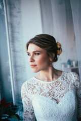 portrait of a bride near a window studio