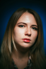 portrait smiling girl on blue background in studio