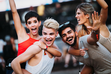 Group of friends having great time on music festival