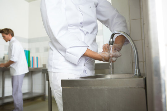 close-up of chef washing his hands