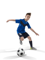 football player kid dribbling with the ball