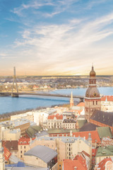 Naklejka premium Beautiful view of the old town and the steeple of the Dome Cathedral near the Daugava River in Riga, Latvia