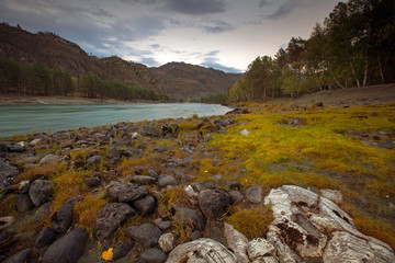 Katun river landscape with beautiful sunset clouds, high mountains and stones on a front
