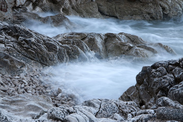 Mystical shore. Fog over sea shore rocks