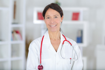 portrait of beautiful middle aged female doctor smiling