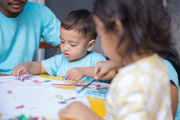 Fototapeta premium child painting water color with dad