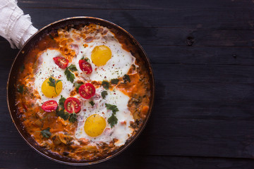 three fried eggs with сherry tomatoes