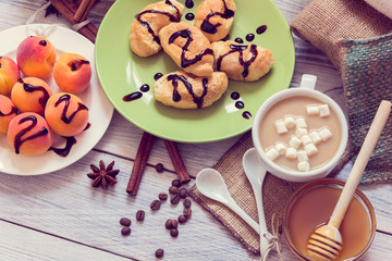 Breakfast of coffee, croissants, apricots, honey, cinnamon and anise