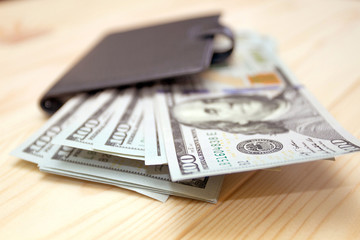 Heap of money and wallet