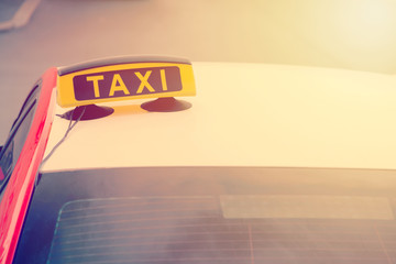 Taxi car is waiting for a passenger on the street. European tourism and travel concept. Toned