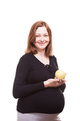 Pregnant woman holds an apple in her hands isolated on white background