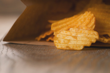 rippled potato chips in paper bag