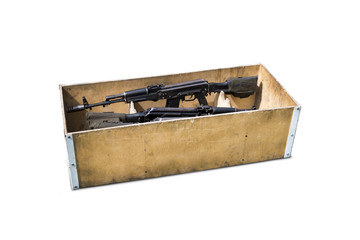 Kalashnikov assault rifles in a wooden box. Arms trade. illegal sale of weapons.An automatic weapon...
