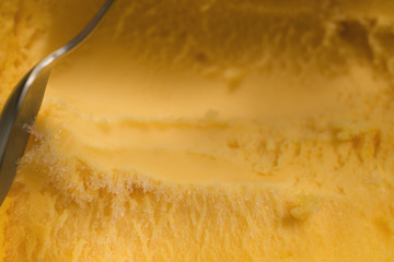 scooping with spoon orange sorbet