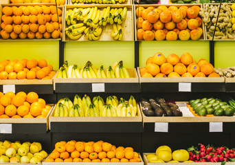 Shelves with fruits and vegetables in a supermarket or a store. Seasonal products.